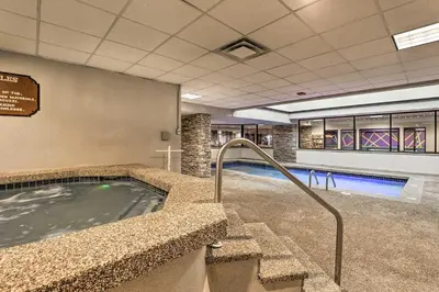a swimming pool with a hot tub and stairs at Mtn Condo with Ski Locker and Pools - 3 Mi to Resort! in Winter Park
