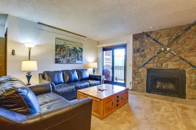 a living room with a couch and a fireplace at Mtn Condo with Ski Locker and Pools - 3 Mi to Resort! in Winter Park