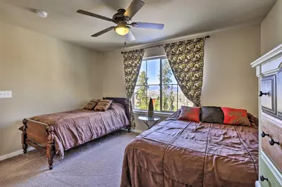 a bedroom with two beds and a ceiling fan at Ski-InandOut Granby Home with Gas Grill and Fire Pit! in Granby