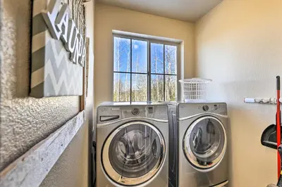 a washer and dryer in a laundry room with a window at Ski-InandOut Granby Home with Gas Grill and Fire Pit! in Granby