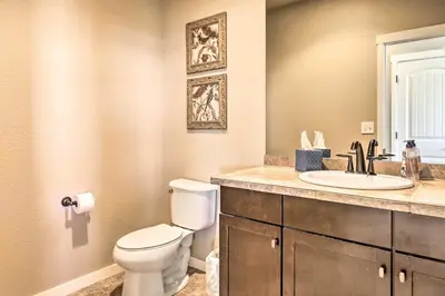 a bathroom with a white toilet and a sink at Ski-InandOut Granby Home with Gas Grill and Fire Pit! in Granby