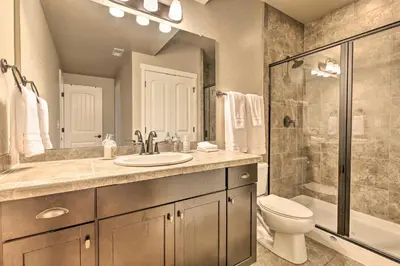 a bathroom with a sink and a toilet and a shower at Ski-InandOut Granby Home with Gas Grill and Fire Pit! in Granby