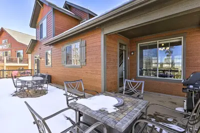 a patio with a table and chairs and a grill at Ski-InandOut Granby Home with Gas Grill and Fire Pit! in Granby
