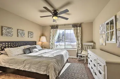 a bedroom with a bed and a ceiling fan at Ski-InandOut Granby Home with Gas Grill and Fire Pit! in Granby