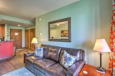 a leather couch in a living room with a mirror at Couples Ski Condo 1 Mi to Breckenridge Golf Club in Breckenridge