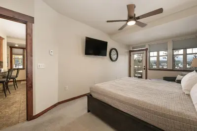 a bedroom with a bed and a clock on the wall at Cozens Pointe E 102 condo in Fraser