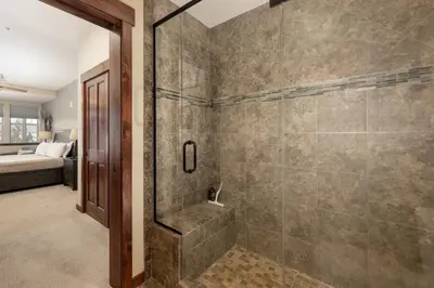 a bathroom with a shower with a glass door at Cozens Pointe E 102 condo in Fraser
