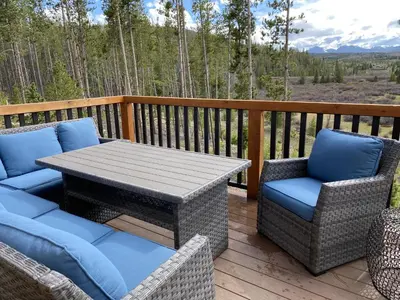 a patio with a table and chairs on a deck at Cozens Pointe E 102 condo in Fraser