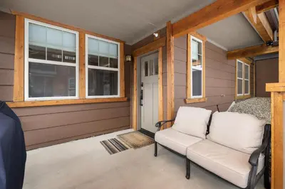 a couch sitting on the porch of a house at Cozens Pointe E 102 condo in Fraser