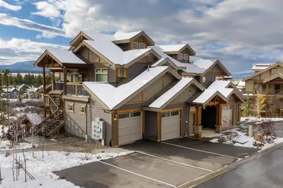 a large house with snow covered roof at Cozens Pointe E 102 condo in Fraser