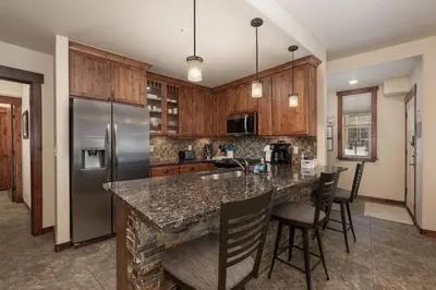 a kitchen with a granite counter top and wooden cabinets at Cozens Pointe E 102 condo in Fraser