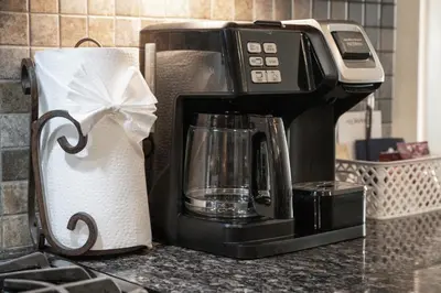 a coffee maker on a counter next to a roll of paper towels at Cozens Pointe E 102 condo in Fraser