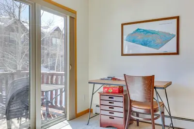a desk and chair in a room with a window at Airy Winter Park Gem with Private Outdoor Hot Tub! in Winter Park