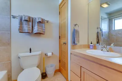 a bathroom with a toilet and a sink at Airy Winter Park Gem with Private Outdoor Hot Tub! in Winter Park
