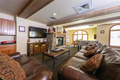 a living room with a leather couch and a fireplace at Full Renovated 1BR -Walk to Gondola & Kids Ski Free condo in Dillon