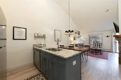 a kitchen with a sink and a dining room at Full Renovated 1BR -Walk to Gondola & Kids Ski Free condo in Dillon