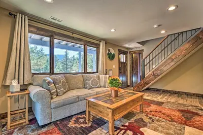 a living room with a couch and a table at Luxe Updated Home with Grill and Hot Tub 4 Mi to RMNP in Estes Park