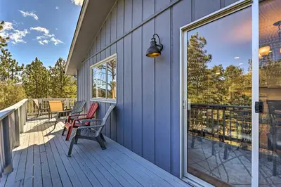 a porch with two chairs and a window at Luxe Updated Home with Grill and Hot Tub 4 Mi to RMNP in Estes Park