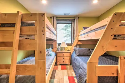 two bunk beds in a small room with a bed at Luxe Updated Home with Grill and Hot Tub 4 Mi to RMNP in Estes Park