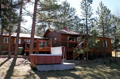 a log cabin with a porch and a deck at Mountain Pine Cabin by Rocky Mountain Resorts- #20NCD0296 in Estes Park