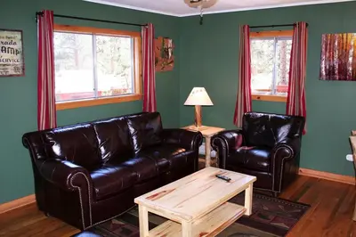 a living room with two leather couches and a coffee table at Mountain Pine Cabin by Rocky Mountain Resorts- #20NCD0296 in Estes Park