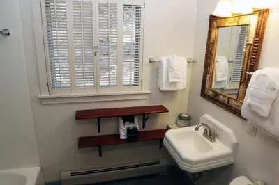 a white bathroom with a sink and a mirror at Mountain Pine Cabin by Rocky Mountain Resorts- #20NCD0296 in Estes Park