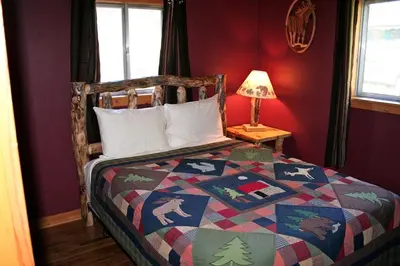 a bedroom with a bed with a colorful quilt at Mountain Pine Cabin by Rocky Mountain Resorts- #20NCD0296 in Estes Park