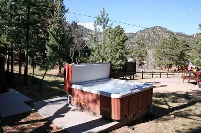 a hot tub sitting on the ground in a yard at Mountain Pine Cabin by Rocky Mountain Resorts- #20NCD0296 in Estes Park