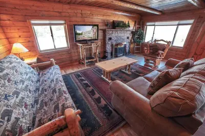 a living room with a couch and a table at Rocky Mountain Retreat 2 by Rocky Mountain Resorts in Estes Park