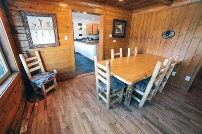 a dining room with a wooden table and chairs at Rocky Mountain Retreat 2 by Rocky Mountain Resorts in Estes Park