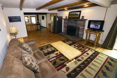 a living room with a couch and a fireplace at Rocky Mountain Retreat 1A by Rocky Mountain Resorts in Estes Park