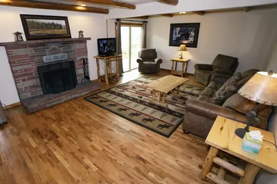 a living room with a couch and a fireplace at Rocky Mountain Retreat 1A by Rocky Mountain Resorts in Estes Park