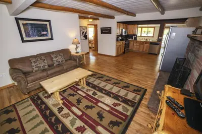 a living room with a couch and a kitchen at Rocky Mountain Retreat 1A by Rocky Mountain Resorts in Estes Park