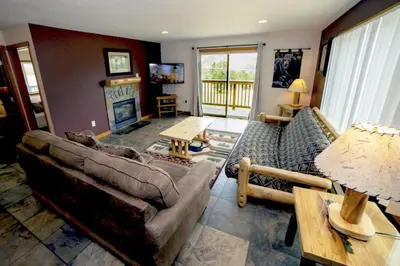 a living room with a couch and a table at Rocky Mountain Retreat 1A by Rocky Mountain Resorts in Estes Park