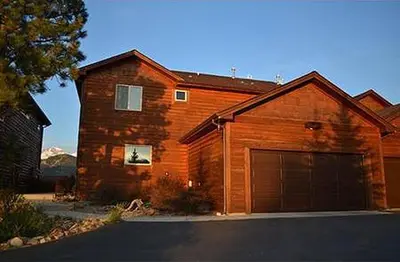a wooden house with a garage in front of it at Virginia Home by Rocky Mountain Resorts- #3106 in Estes Park