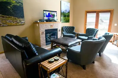 a living room with leather furniture and a fireplace at Virginia Home by Rocky Mountain Resorts- #3106 in Estes Park