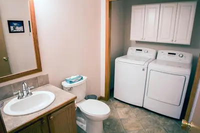 a bathroom with a washer and a toilet and a sink at Virginia Home by Rocky Mountain Resorts- #3106 in Estes Park