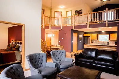 a living room with a couch and chairs and a staircase at Virginia Home by Rocky Mountain Resorts- #3106 in Estes Park