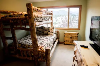 a bedroom with two bunk beds and a window at Virginia Home by Rocky Mountain Resorts- #3106 in Estes Park