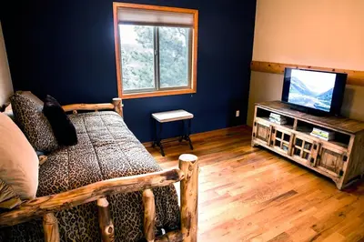a living room with a bed and a television at Virginia Home by Rocky Mountain Resorts- #3106 in Estes Park