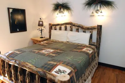 a bedroom with a wooden bed in a room at Stonehaven Home by Rocky Mountain Resorts- #3384 in Estes Park
