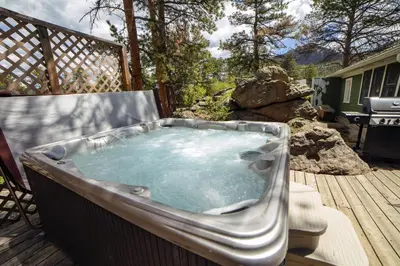 a jacuzzi tub on a deck in a yard at Monte Verde by Rocky Mountain Resorts- #20NCD0297 in Estes Park