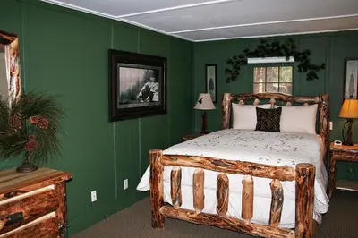 a bedroom with green walls and a wooden bed at Monte Verde by Rocky Mountain Resorts- #20NCD0297 in Estes Park