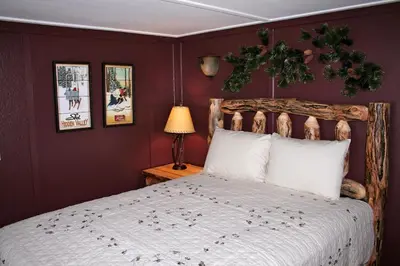 a bedroom with a large bed with a wooden headboard at Monte Verde by Rocky Mountain Resorts- #20NCD0297 in Estes Park