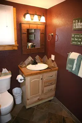 a bathroom with a sink and a toilet and a mirror at Monte Verde by Rocky Mountain Resorts- #20NCD0297 in Estes Park