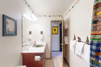 a bathroom with a sink and a mirror at Hi Country Haus 6-15 in Winter Park