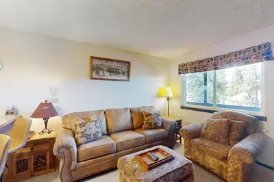 a living room with a couch and a chair at Hi Country Haus 6-15 in Winter Park
