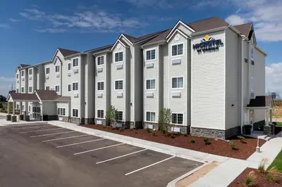an exterior view of a hotel with a parking lot at Microtel Inn & Suites by Wyndham Loveland in Loveland