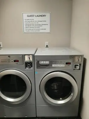 two washing machines sitting next to each other in a room at Microtel Inn & Suites by Wyndham Loveland in Loveland
