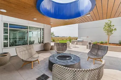 a patio with chairs and a table and a blue light at Element Denver International Airport in Denver